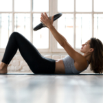 Young,Sporty,Attractive,Woman,Doing,Toning,Pilates,Exercise,For,Abs